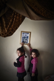 KABUL, AFGHANISTAN-APRIL, 2013: Omullbanin Bakhtar (5)and her sister Maryam (6) are looking at their mother's portrait, Amina, a female Special Force, currently on operation in another province in KAndahar. (Picture by Veronique de Viguerie/Reportage by Getty Images)