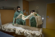 MULHOUSE, FRANCE- 1 APRIL 2020: Jeremy Walter and Laura Wioland undertakers, are taking off the dead body of an old woman who died of Covid 19 in an hospital for old person. (Picture by Veronique de Viguerie/Getty Images)