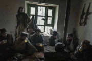 Nangahar, Afghanistan-Dec, 2019: Mollah Tareq (with the radio sitting in the corner) and his fighters are having lunch in the village in the mountains that they are controling. A territory they took from Daesh about two months ago. (Picture by Veronique de Viguerie/Getty Reportage)